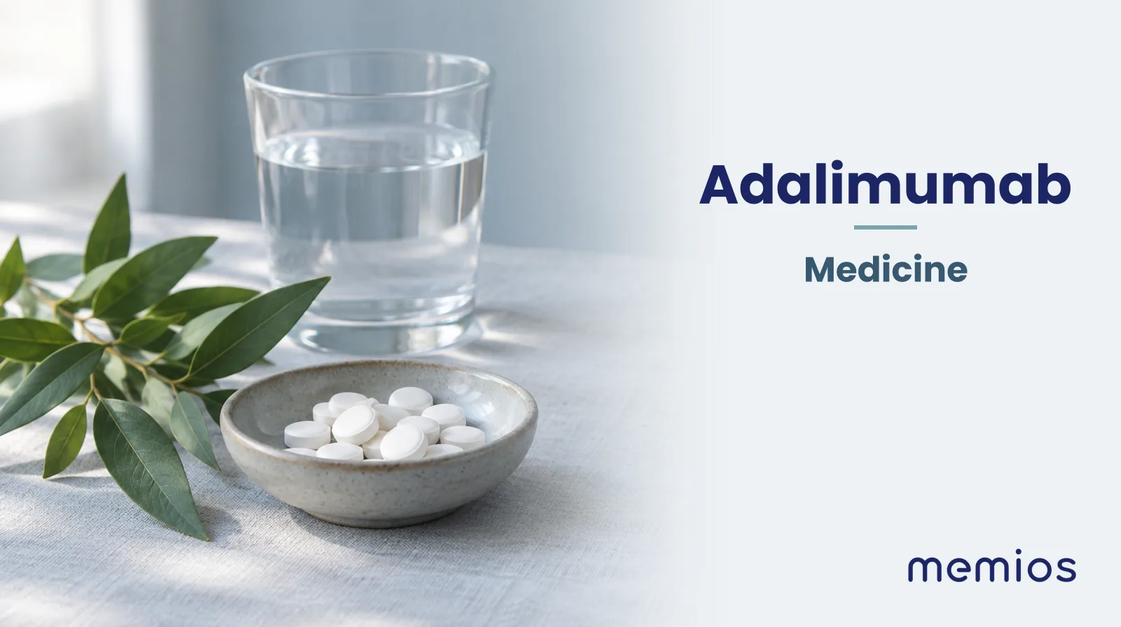 Photograph for Adalimumab: plain unmarked tablets in a dish beside a glass of water on pale linen.