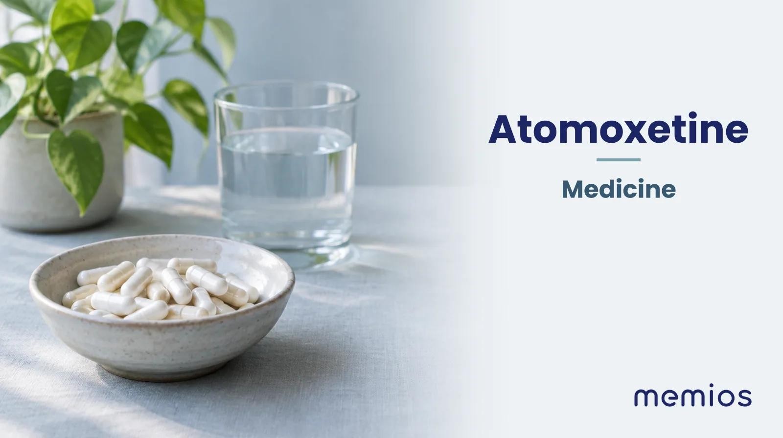 Photograph for Atomoxetine: plain unmarked tablets in a dish beside a glass of water on pale linen.