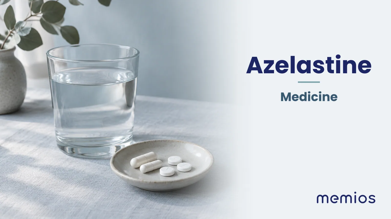 Photograph for Azelastine: plain unmarked tablets in a dish beside a glass of water on pale linen.