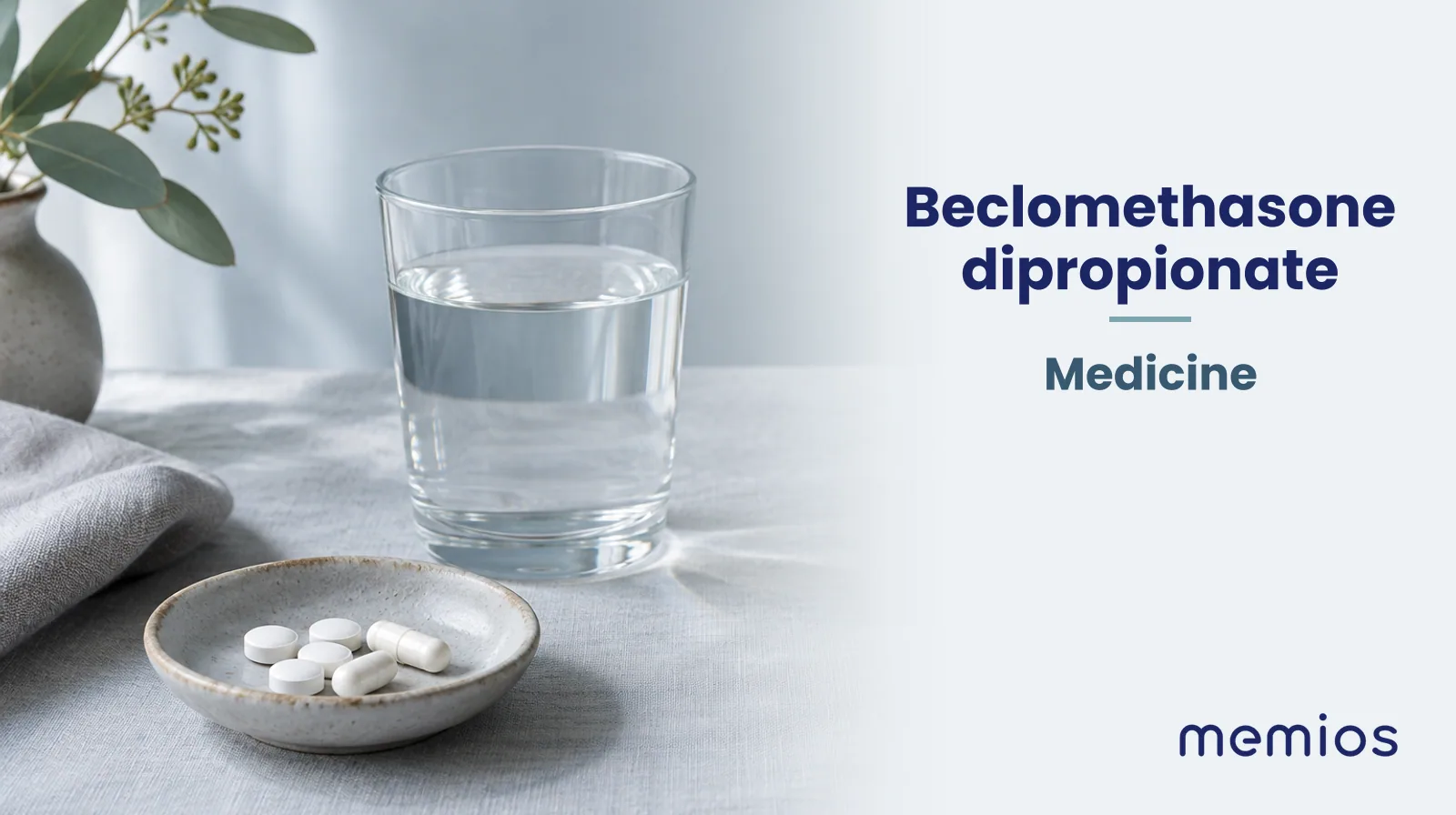 Photograph for Beclomethasone dipropionate: plain unmarked tablets in a dish beside a glass of water on pale linen.