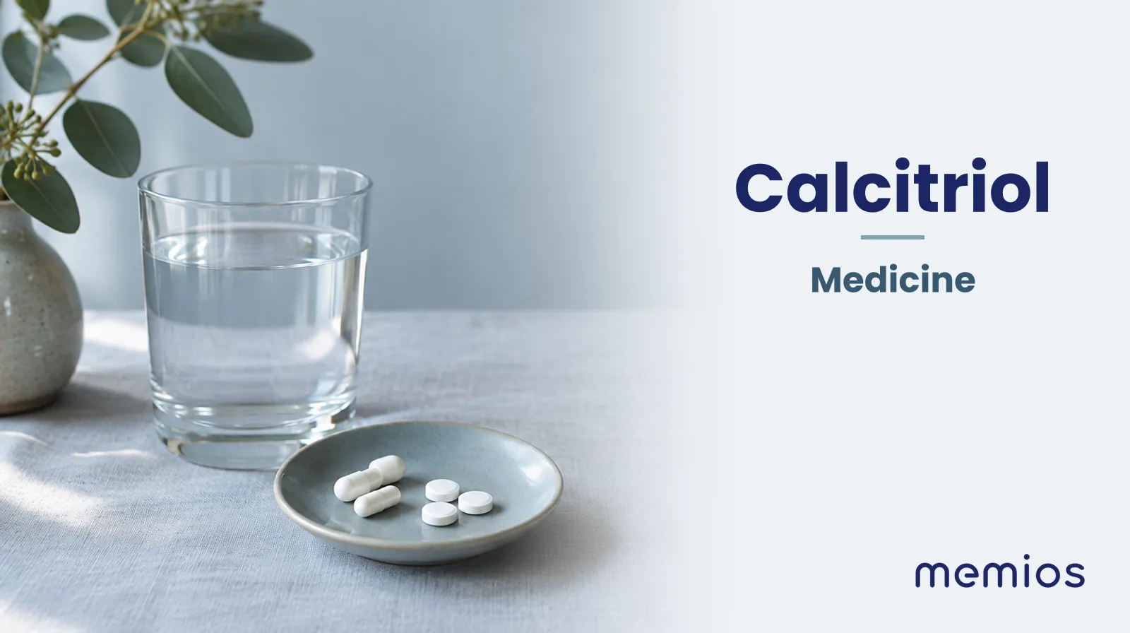Photograph for Calcitriol: plain unmarked tablets in a dish beside a glass of water on pale linen.