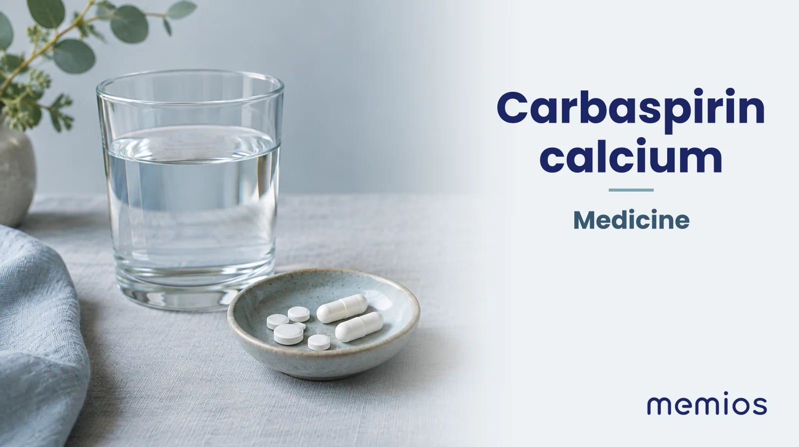 Photograph for Carbaspirin calcium: plain unmarked tablets in a dish beside a glass of water on pale linen.