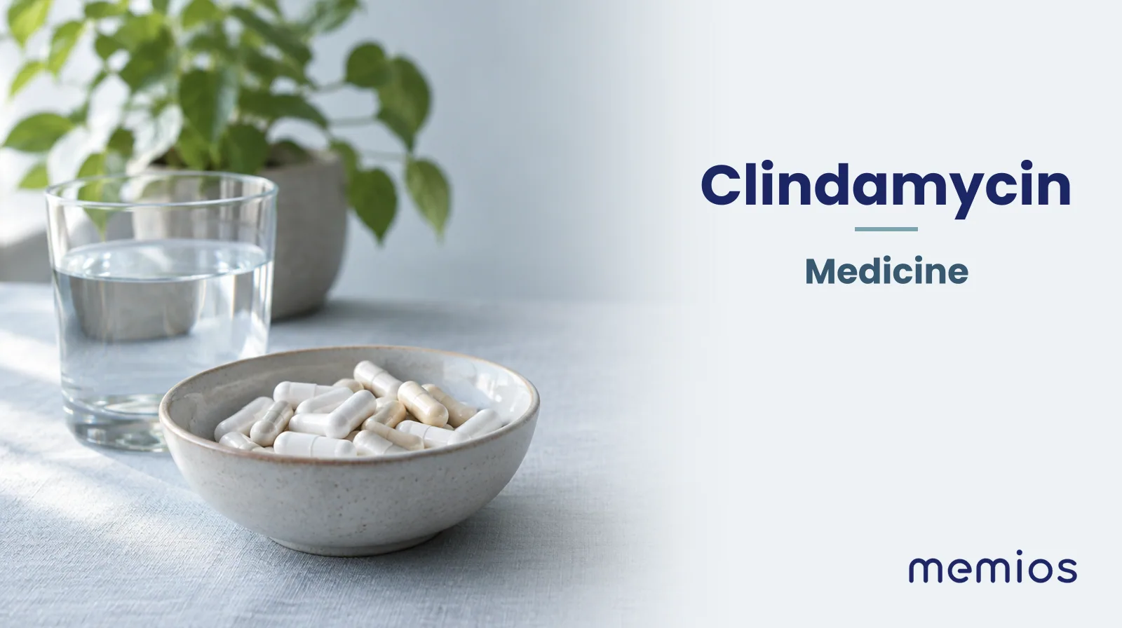 Photograph for Clindamycin: plain unmarked tablets in a dish beside a glass of water on pale linen.