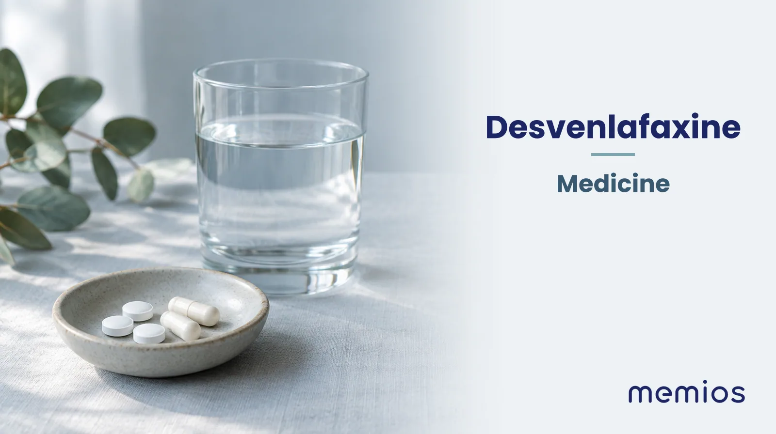Photograph for Desvenlafaxine: plain unmarked tablets in a dish beside a glass of water on pale linen.