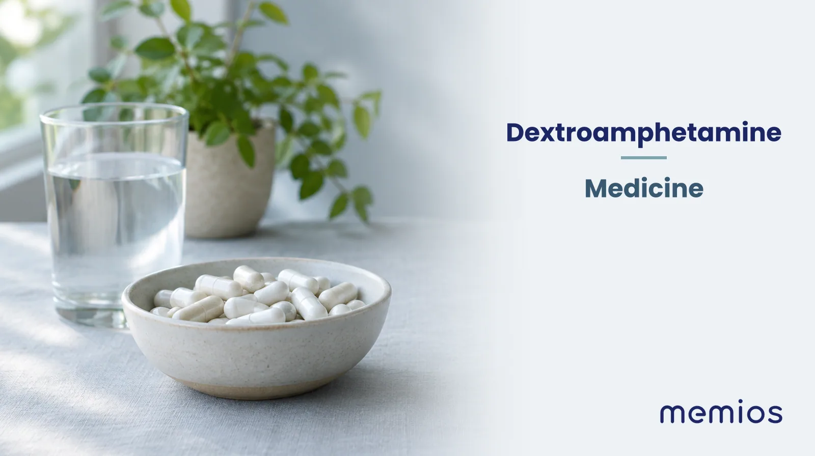 Photograph for Dextroamphetamine: plain unmarked tablets in a dish beside a glass of water on pale linen.