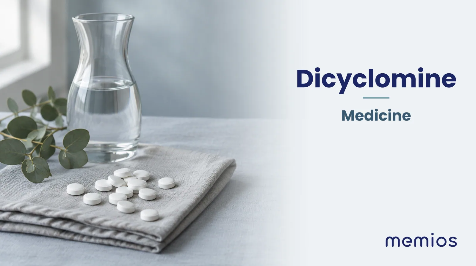 Photograph for Dicyclomine: plain unmarked tablets in a dish beside a glass of water on pale linen.