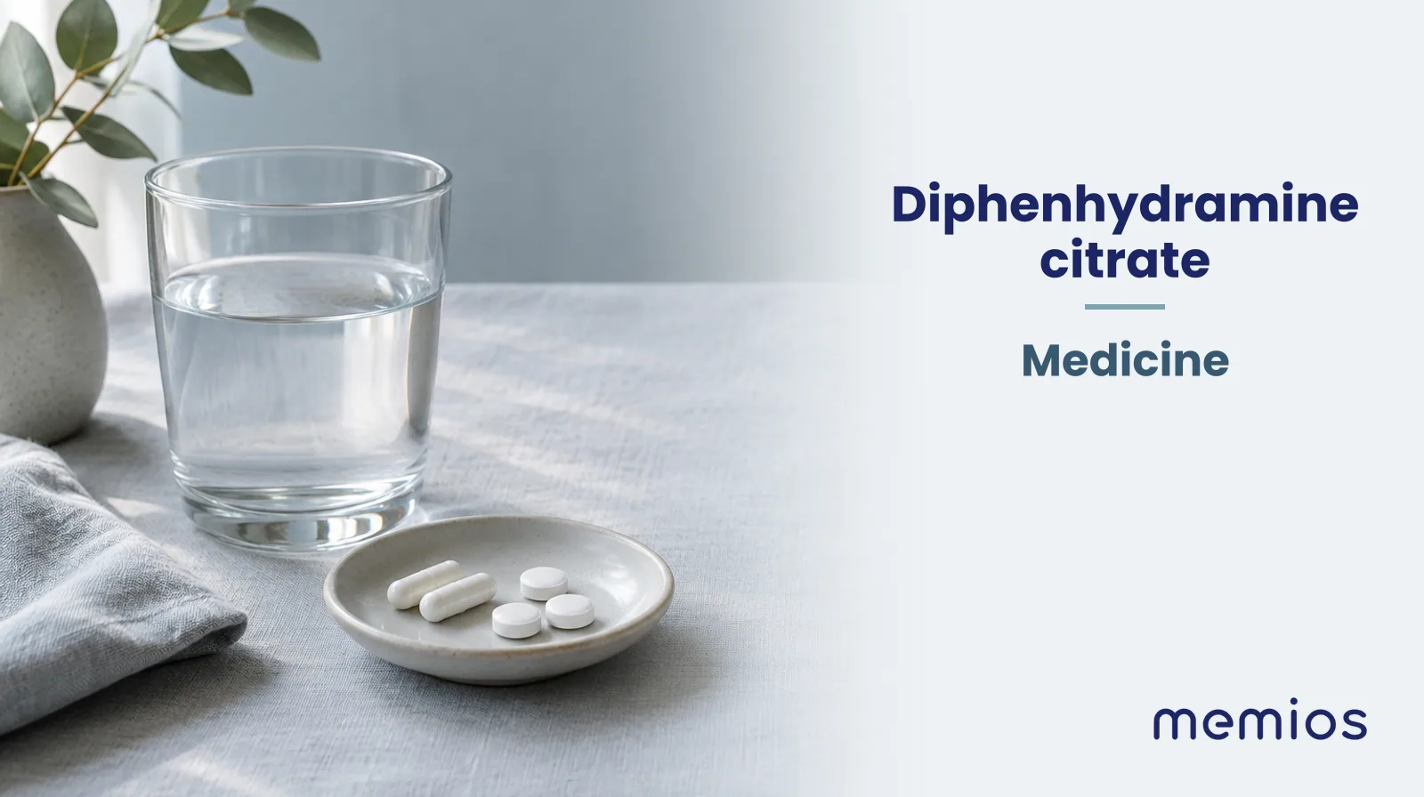 Photograph for Diphenhydramine citrate: plain unmarked tablets in a dish beside a glass of water on pale linen.