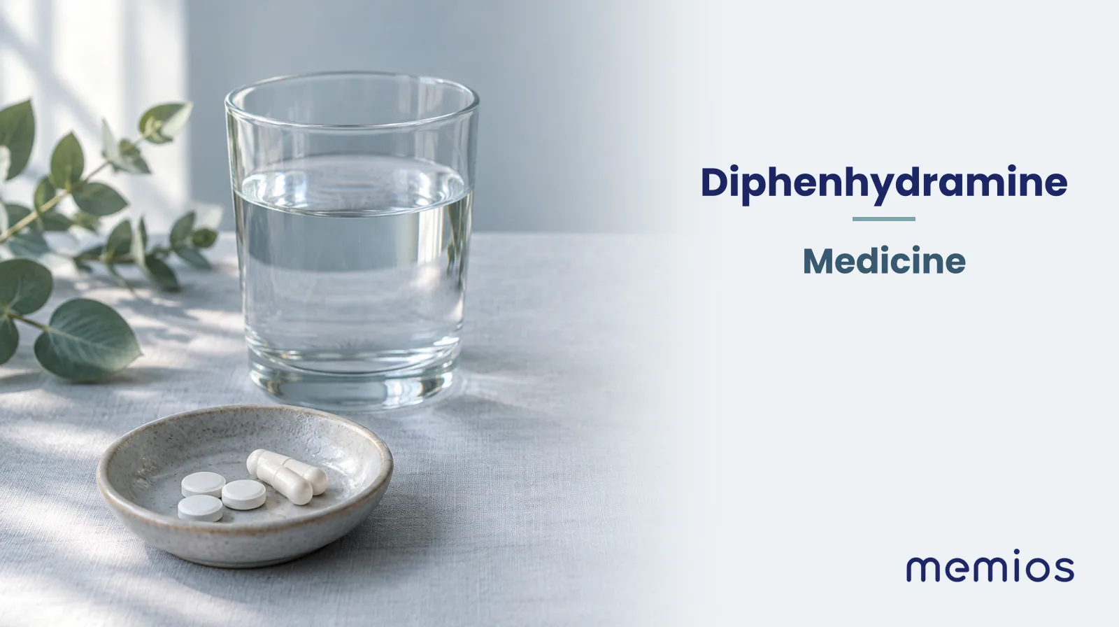 Photograph for Diphenhydramine: plain unmarked tablets in a dish beside a glass of water on pale linen.