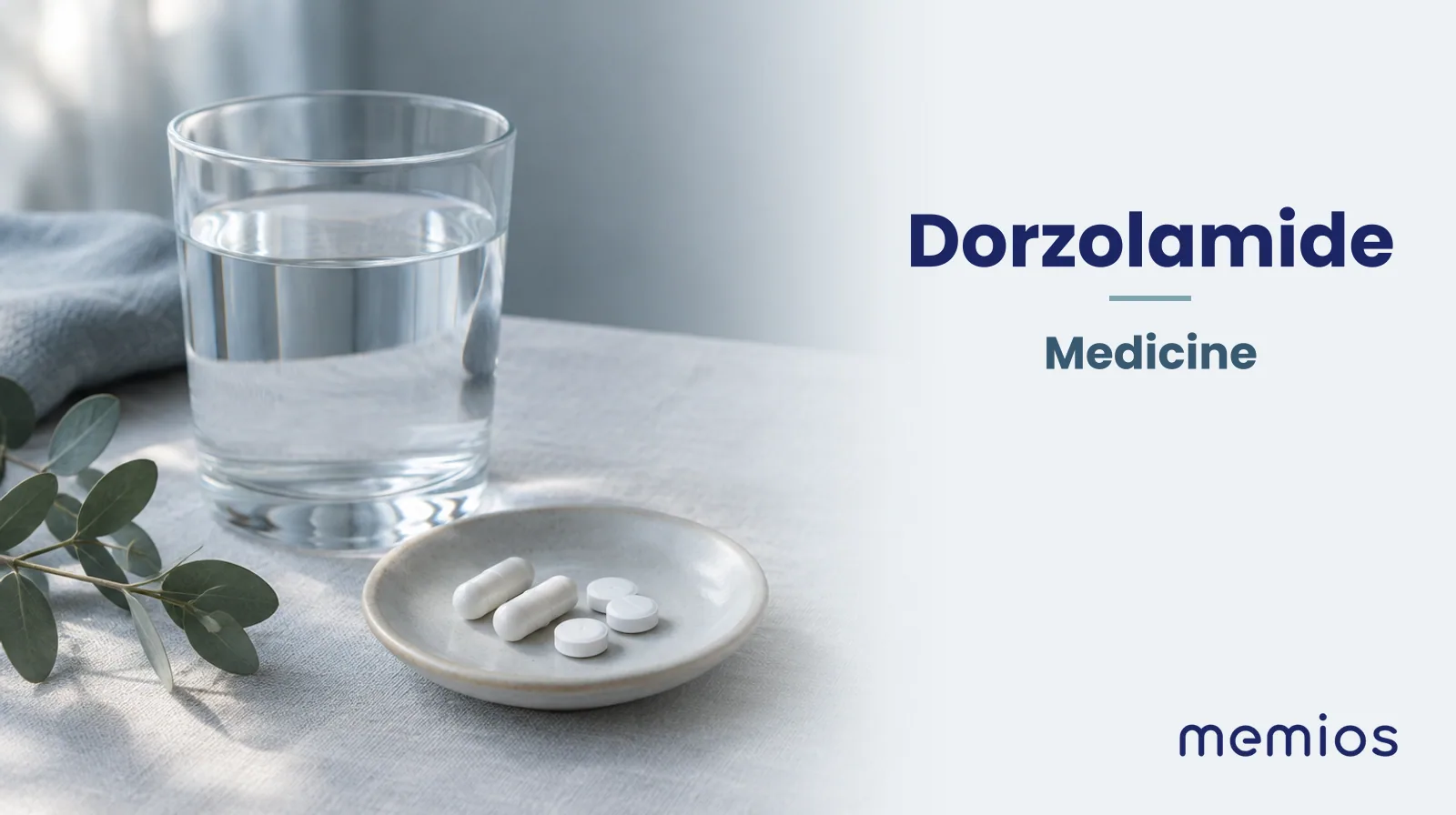 Photograph for Dorzolamide: plain unmarked tablets in a dish beside a glass of water on pale linen.