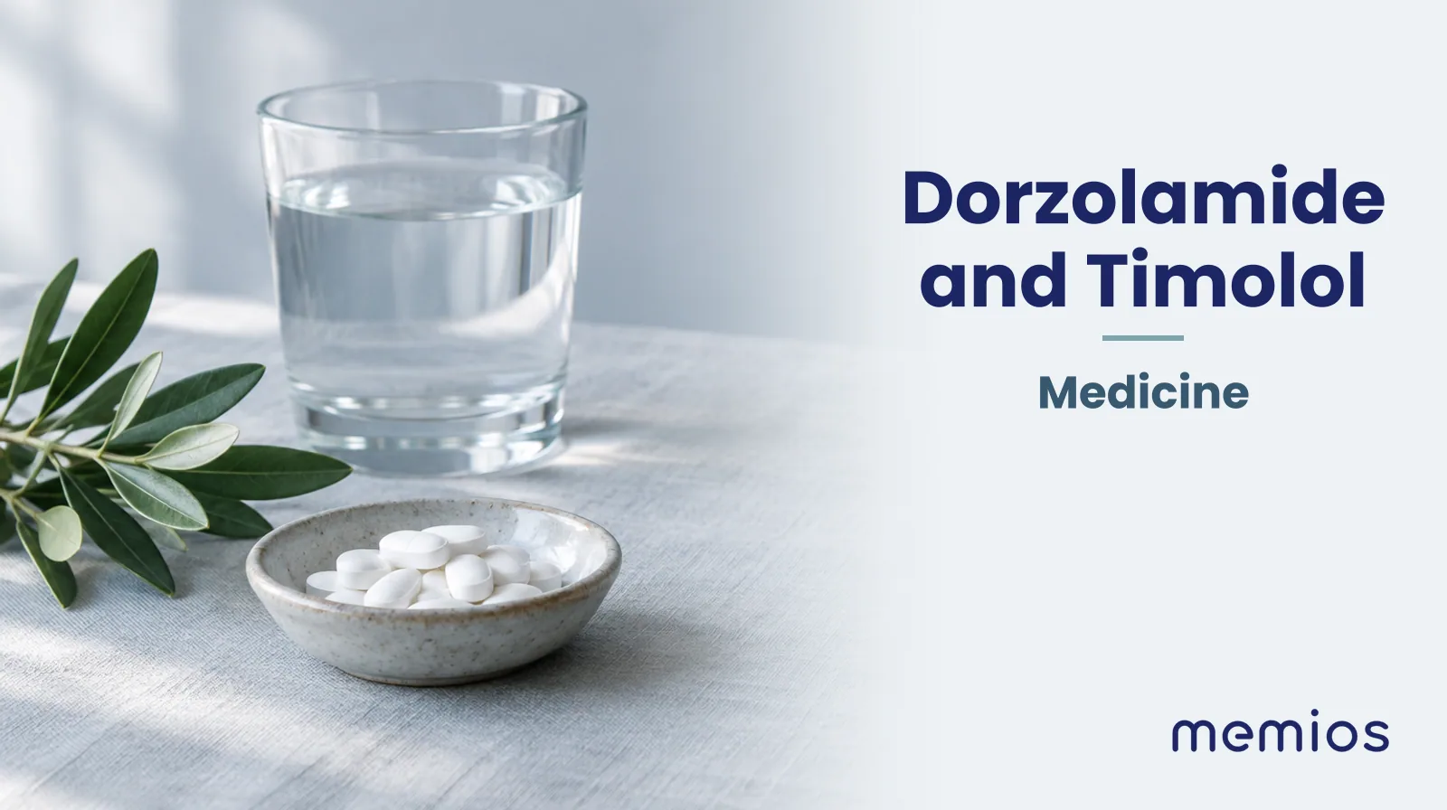 Photograph for Dorzolamide and Timolol: plain unmarked tablets in a dish beside a glass of water on pale linen.