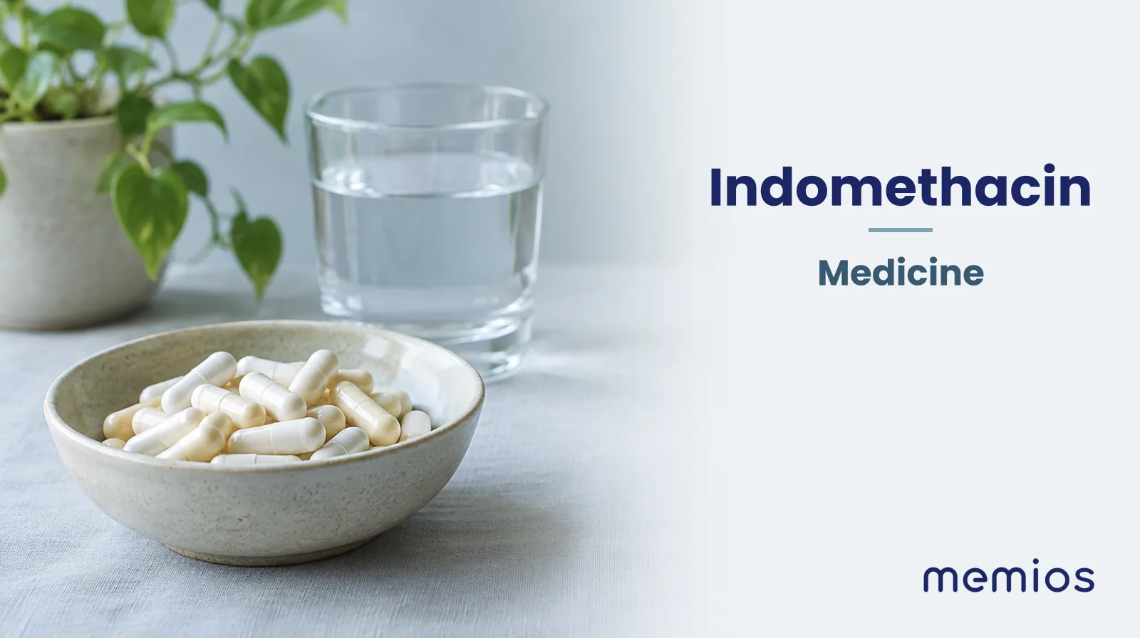 Photograph for Indomethacin: plain unmarked tablets in a dish beside a glass of water on pale linen.