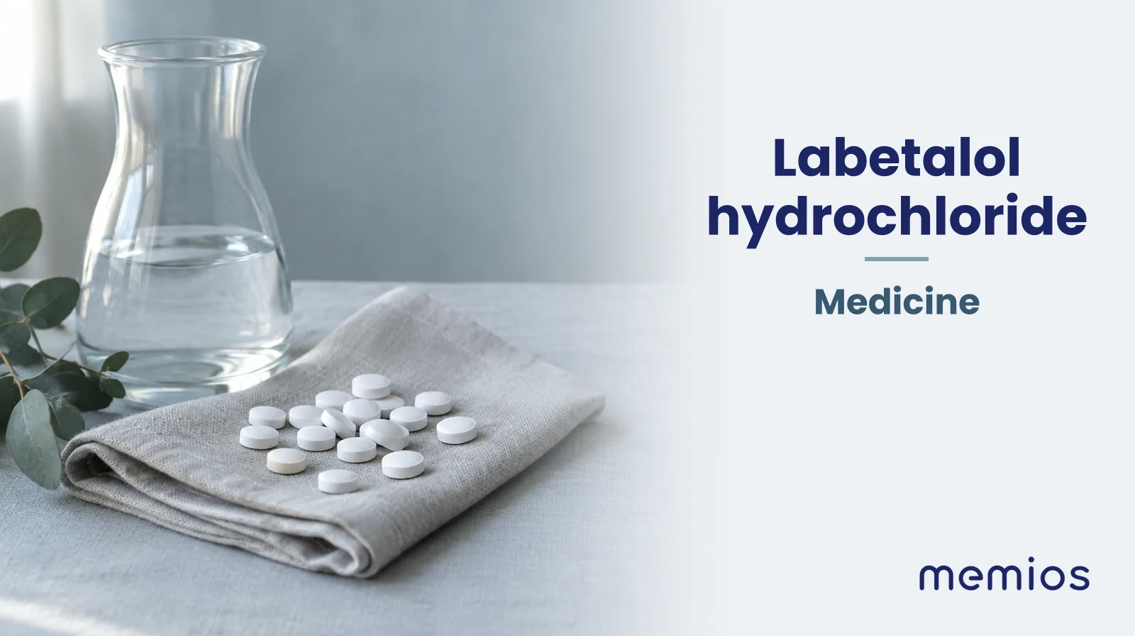 Photograph for Labetalol hydrochloride: plain unmarked tablets in a dish beside a glass of water on pale linen.