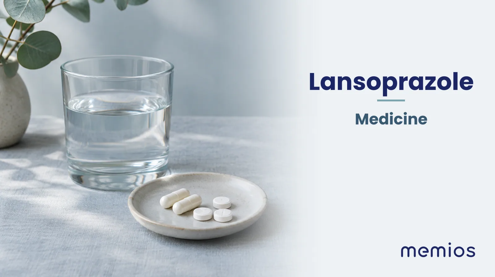 Photograph for Lansoprazole: plain unmarked tablets in a dish beside a glass of water on pale linen.