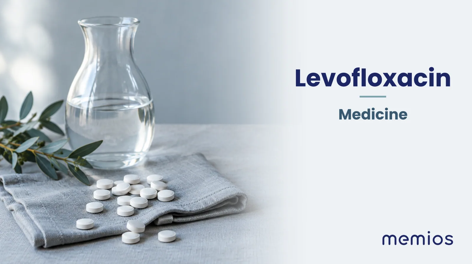 Photograph for Levofloxacin: plain unmarked tablets in a dish beside a glass of water on pale linen.