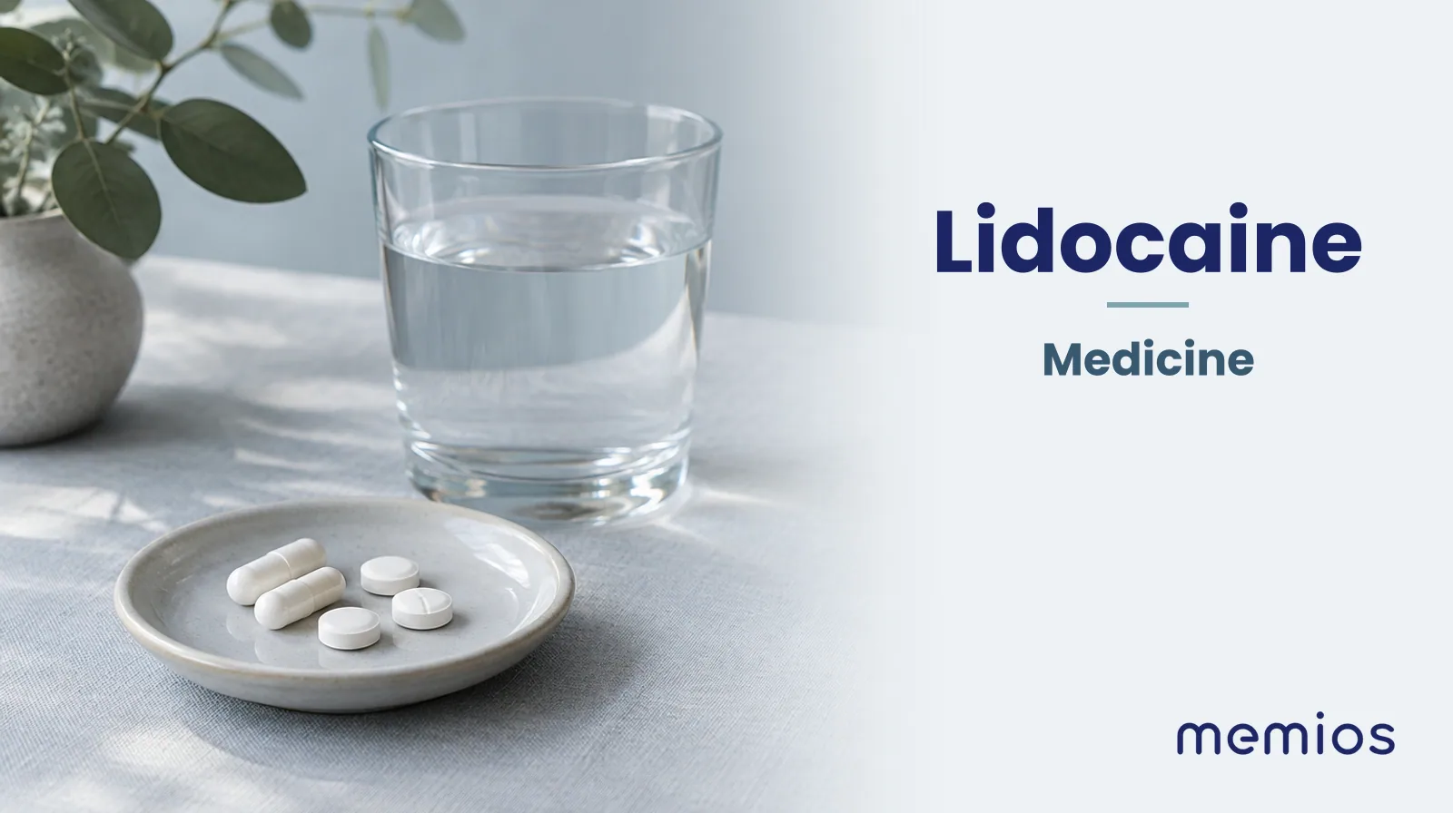 Photograph for Lidocaine: plain unmarked tablets in a dish beside a glass of water on pale linen.