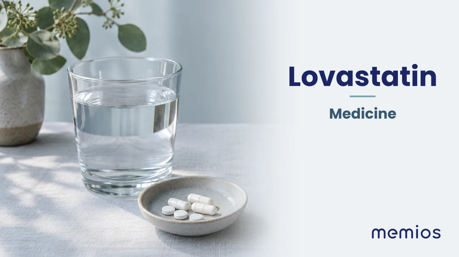 Photograph for Lovastatin: plain unmarked tablets in a dish beside a glass of water on pale linen.