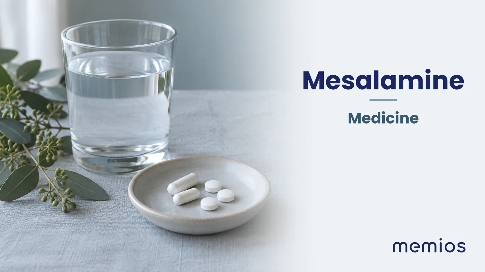 Photograph for Mesalamine: plain unmarked tablets in a dish beside a glass of water on pale linen.
