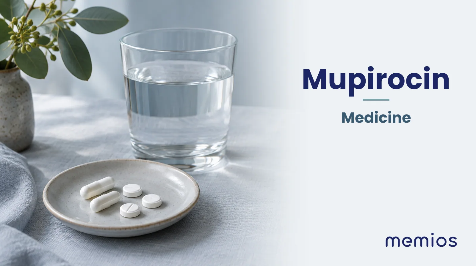 Photograph for Mupirocin: plain unmarked tablets in a dish beside a glass of water on pale linen.