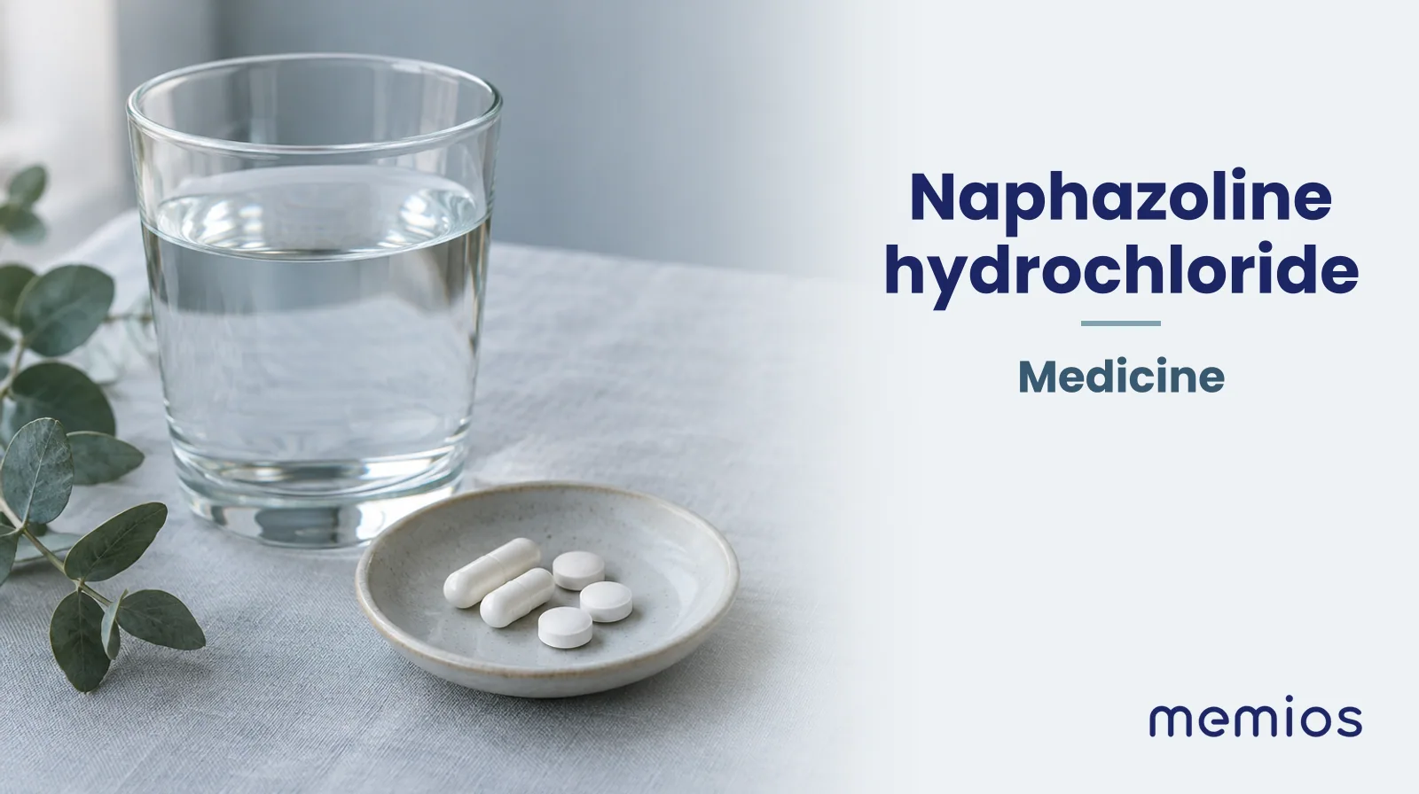 Photograph for Naphazoline hydrochloride: plain unmarked tablets in a dish beside a glass of water on pale linen.