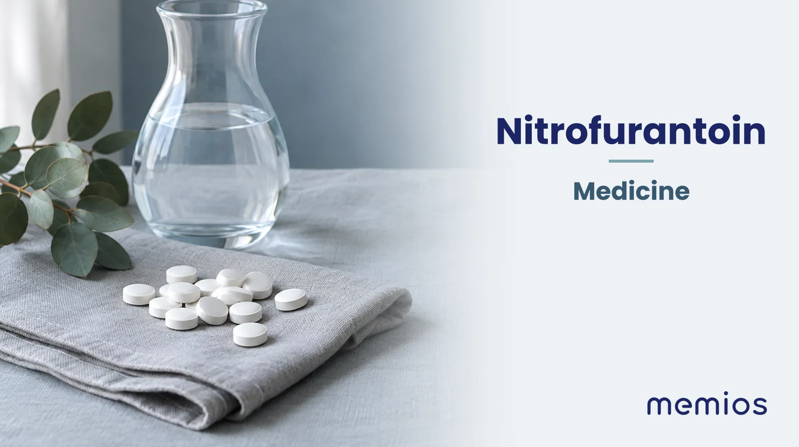 Photograph for Nitrofurantoin: plain unmarked tablets in a dish beside a glass of water on pale linen.