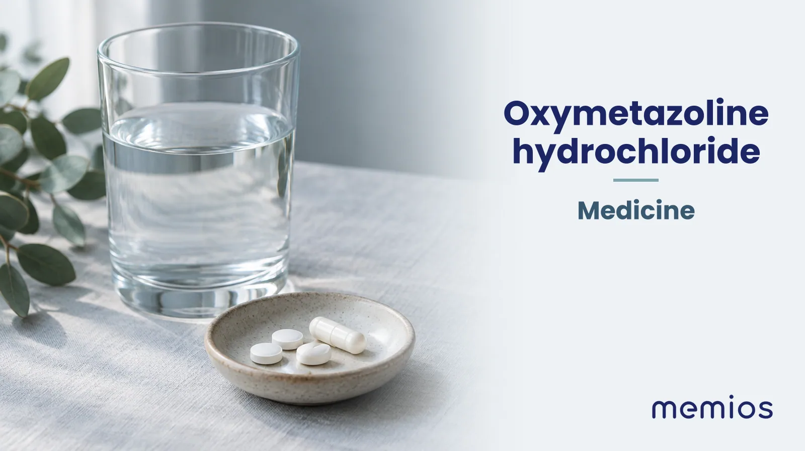 Photograph for Oxymetazoline hydrochloride: plain unmarked tablets in a dish beside a glass of water on pale linen.