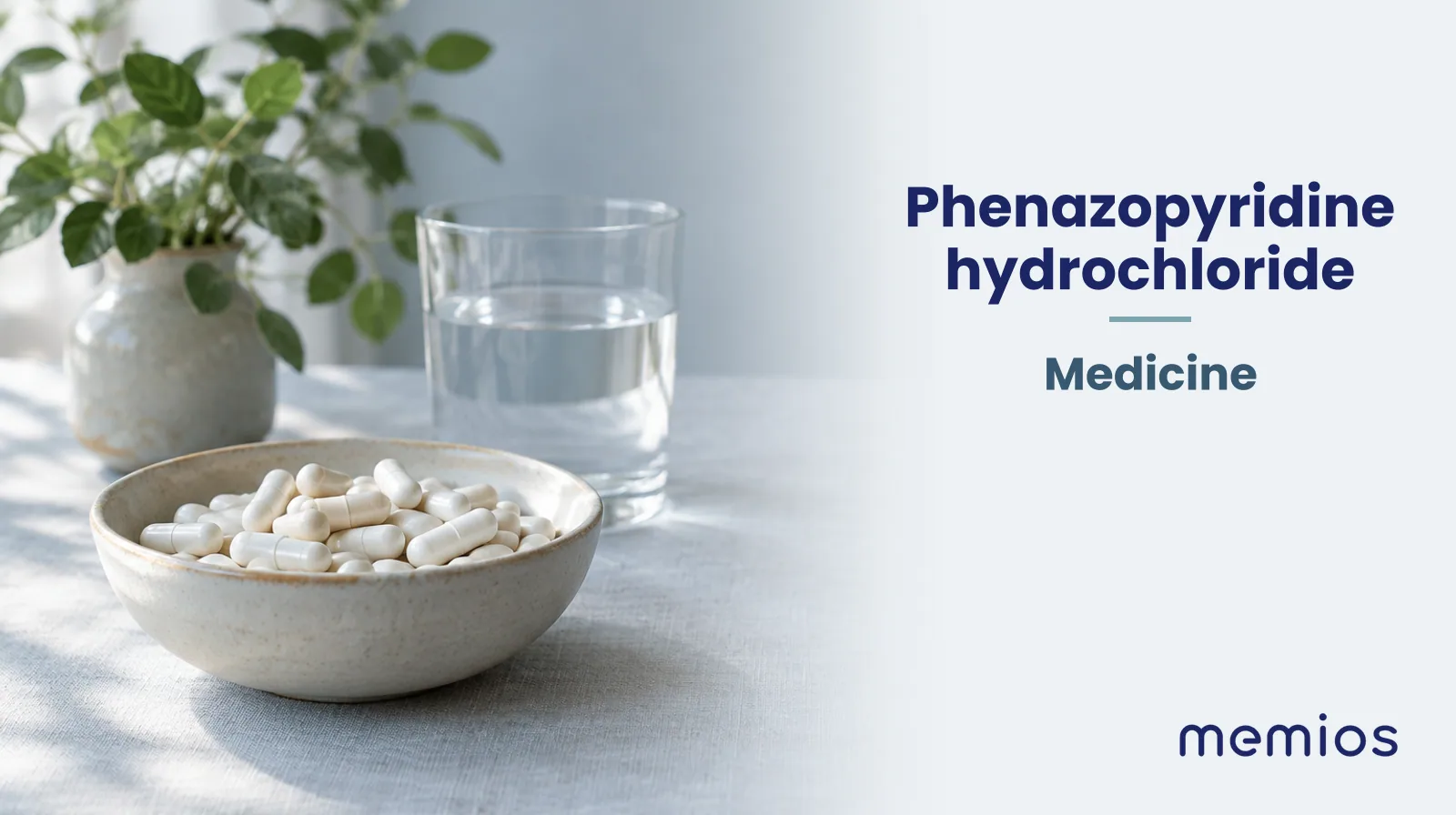 Photograph for Phenazopyridine hydrochloride: plain unmarked tablets in a dish beside a glass of water on pale linen.