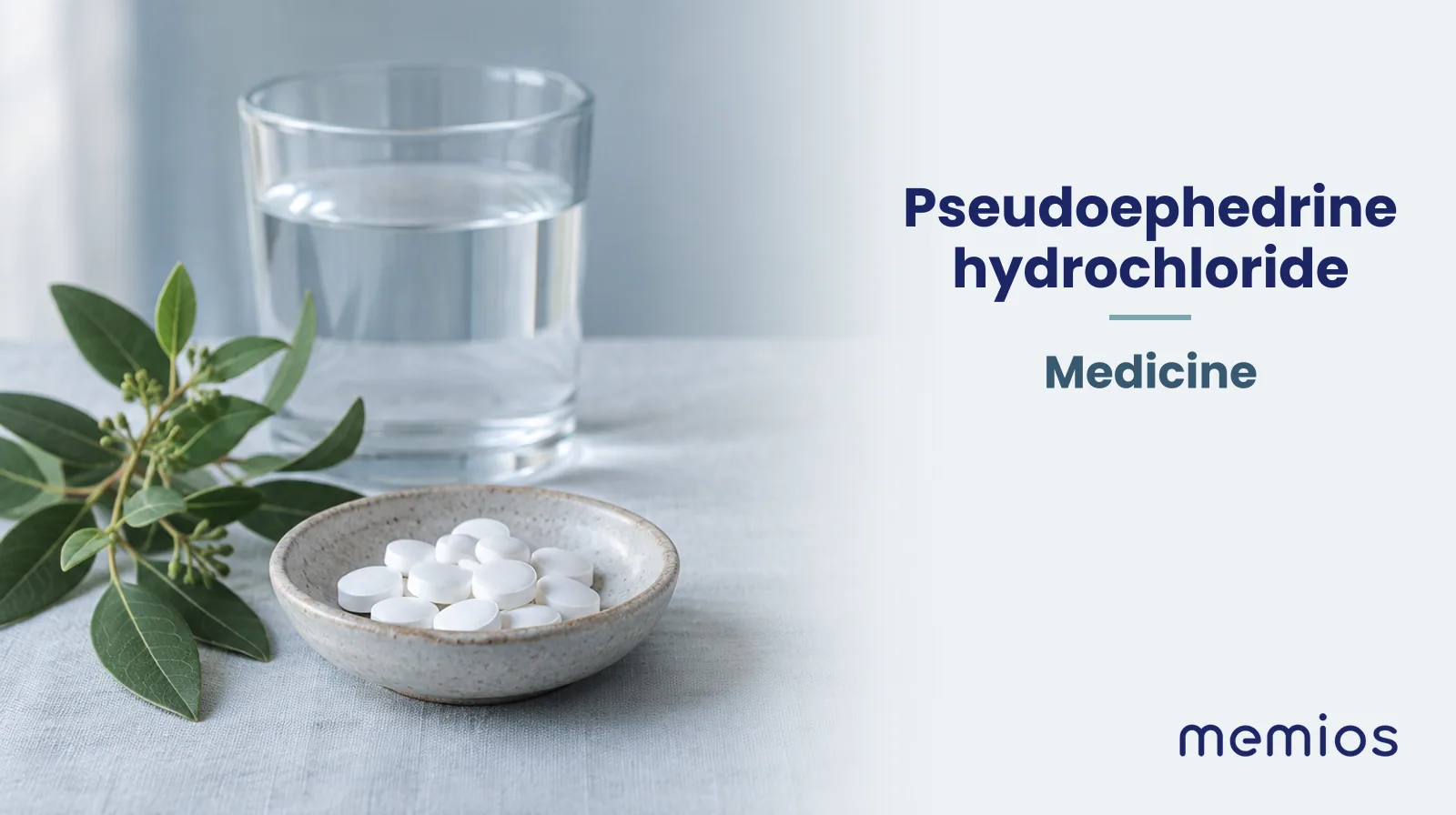 Photograph for Pseudoephedrine hydrochloride: plain unmarked tablets in a dish beside a glass of water on pale linen.