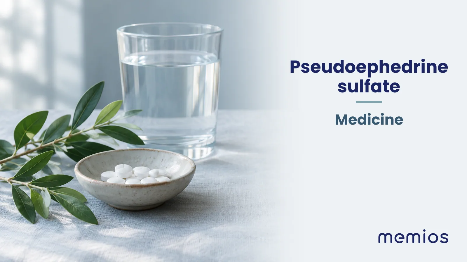 Photograph for Pseudoephedrine sulfate: plain unmarked tablets in a dish beside a glass of water on pale linen.