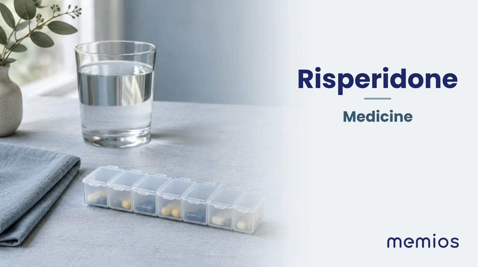 Photograph for Risperidone: plain unmarked tablets in a dish beside a glass of water on pale linen.