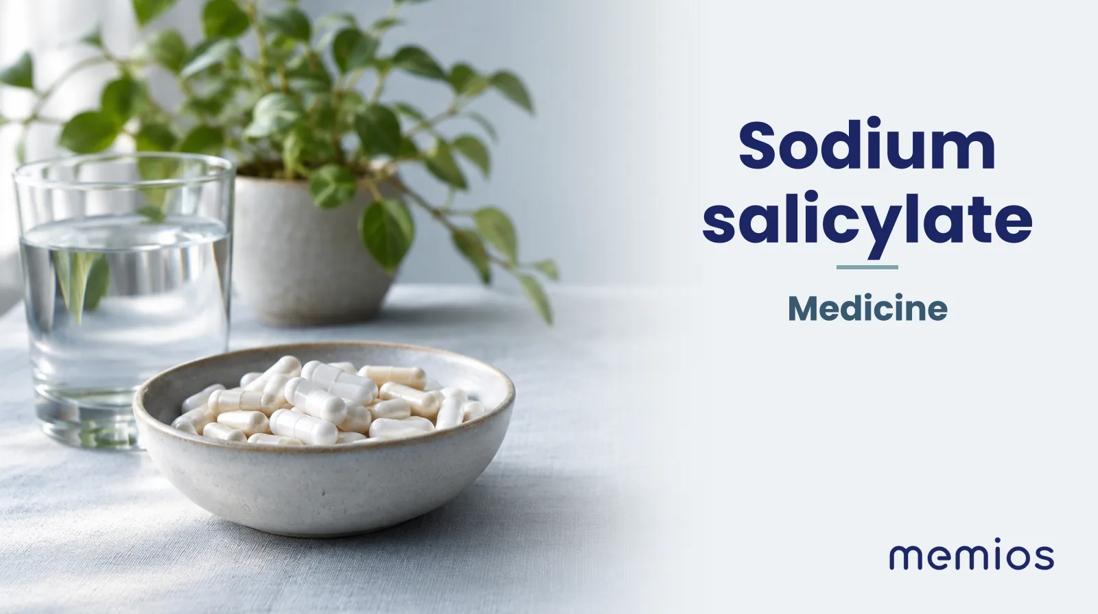 Photograph for Sodium salicylate: plain unmarked tablets in a dish beside a glass of water on pale linen.