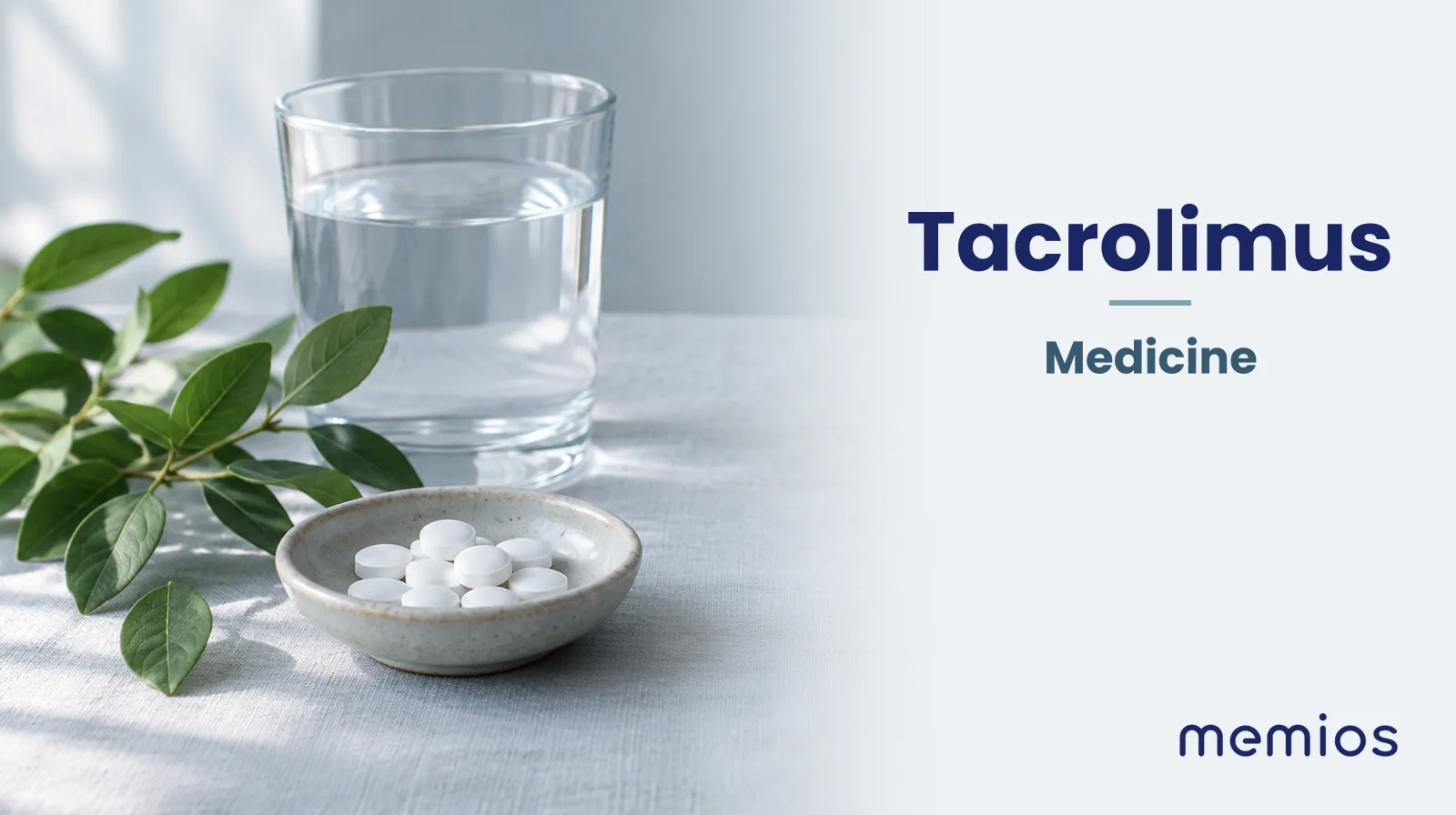 Photograph for Tacrolimus: plain unmarked tablets in a dish beside a glass of water on pale linen.