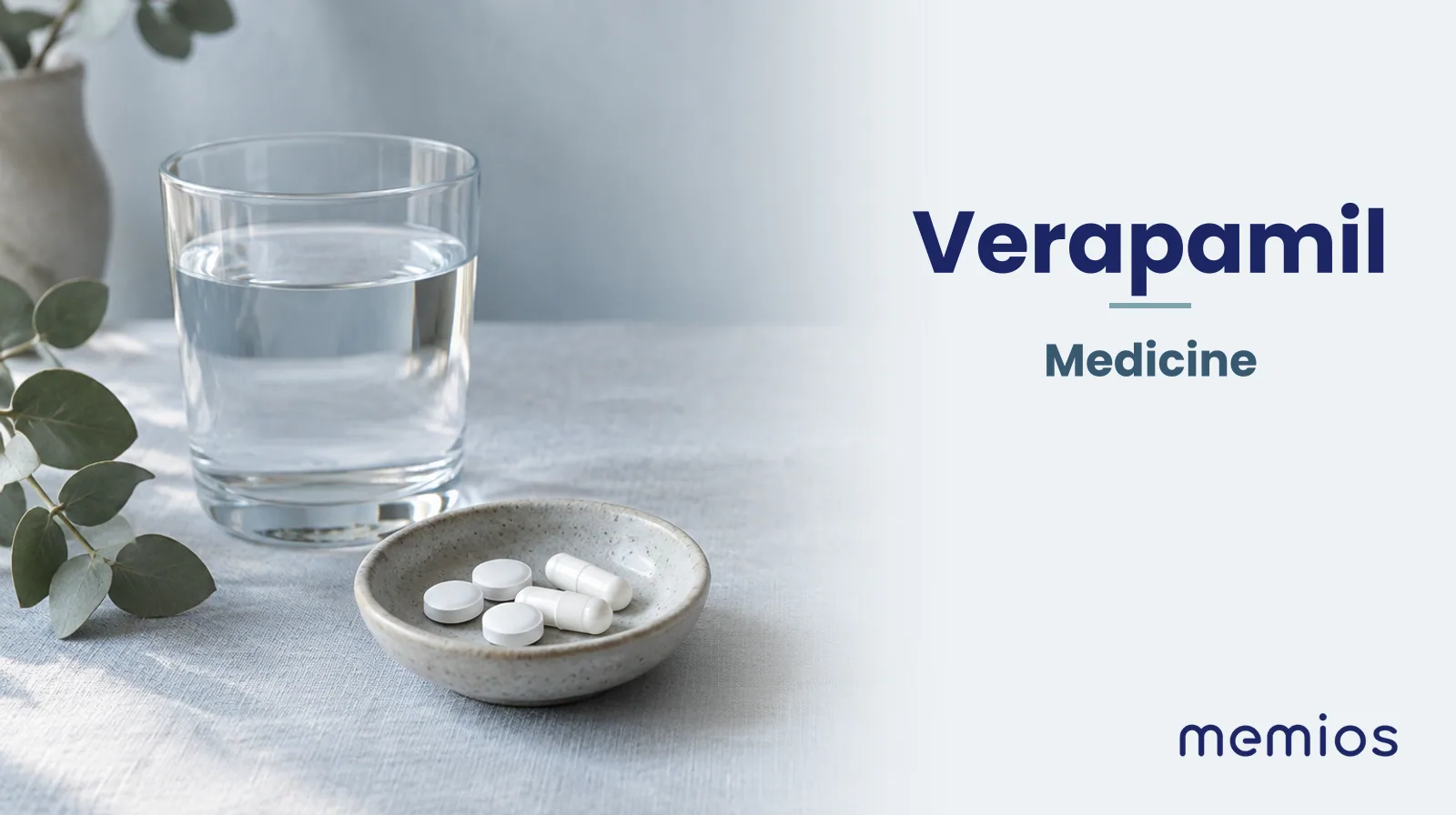 Photograph for Verapamil: plain unmarked tablets in a dish beside a glass of water on pale linen.